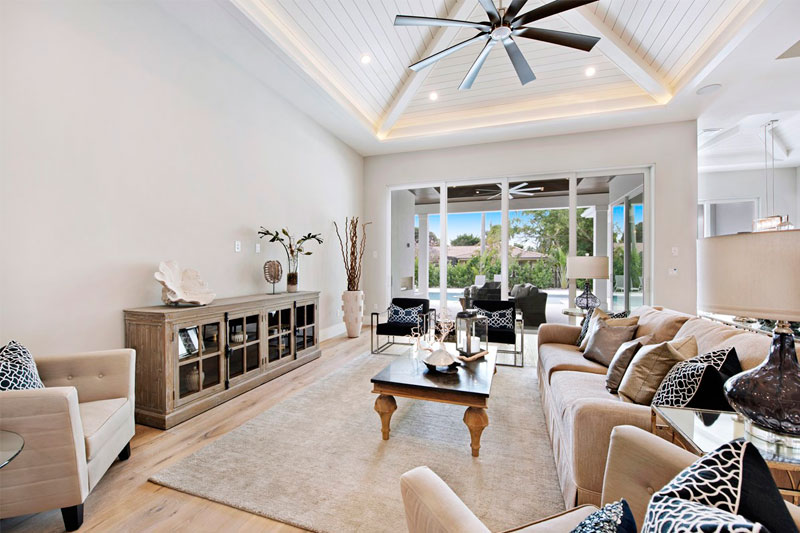 luxurious home living room with couch, coffee table, and white walls